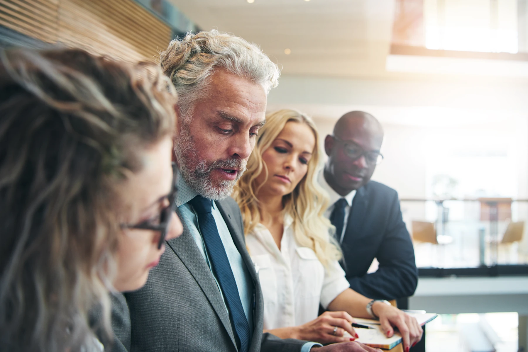 Business leaders discussing a project in a bright office
