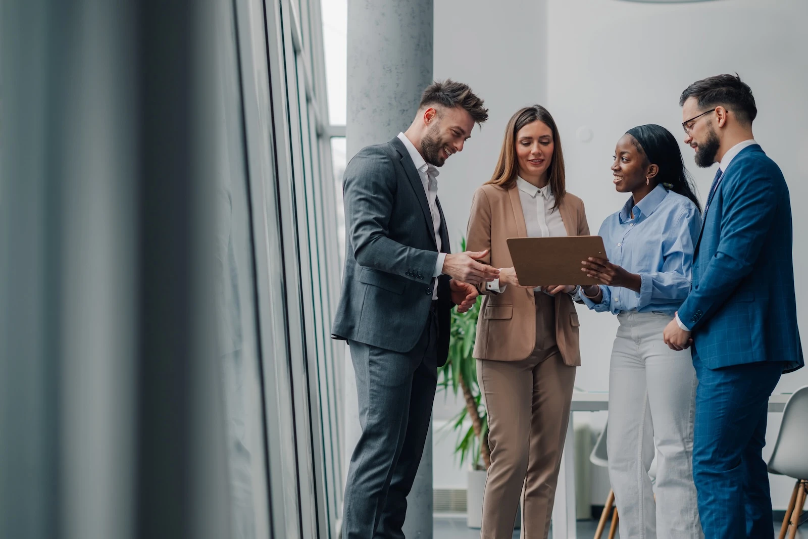Four colleagues discussing work together
