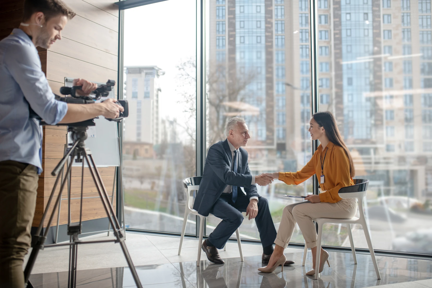 A leader preparing for an interview with a camera crew